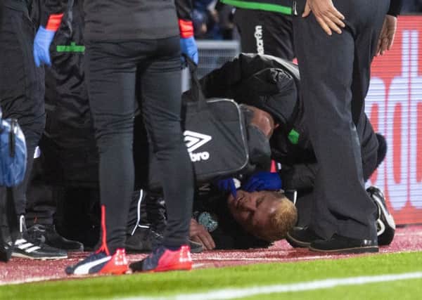Hibs manager Neil Lennon lies on the ground after being struck by an object from the crowd. Picture: Craig Williamson/SNS