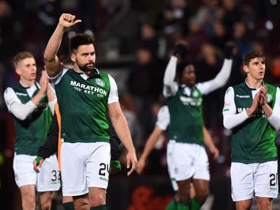 The Hibs players salute their supporters at full-time.