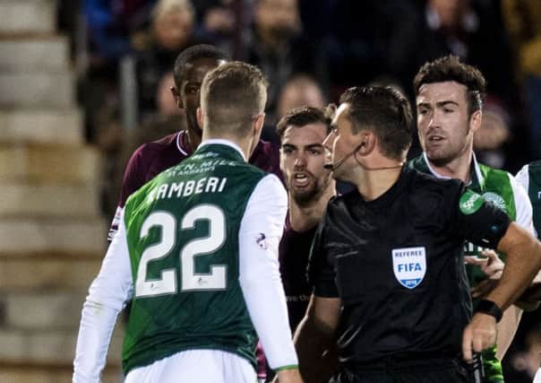 Referee Andrew Dallas comes between Florian Kamberi and Ben Garuccio during the derby