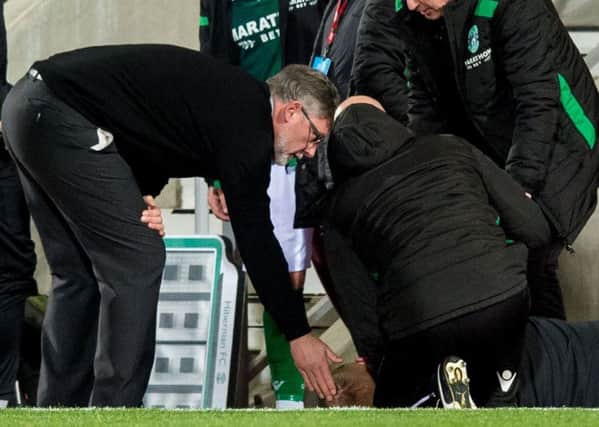 Craig Levein consoles Neil Lennon after the Hibs boss was struck by a coin