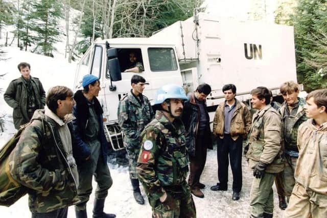 Dutch soldiers chatting with Bosnian Moslem fighters in Vares, Bosnia.