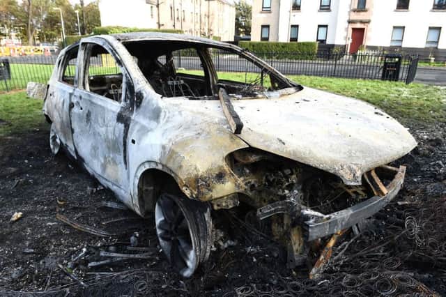 A burnt out car on the streets in the aftermath of Bonfire Night trouble in Edinburgh last year. Pic: Lisa Ferguson