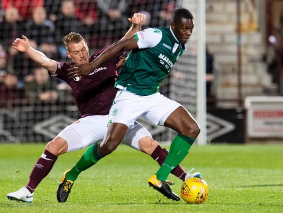 Hibs midfielder Marvin Bartley holds off his Hearts counterpart Oliver Bozanic. Picture: SNS Group