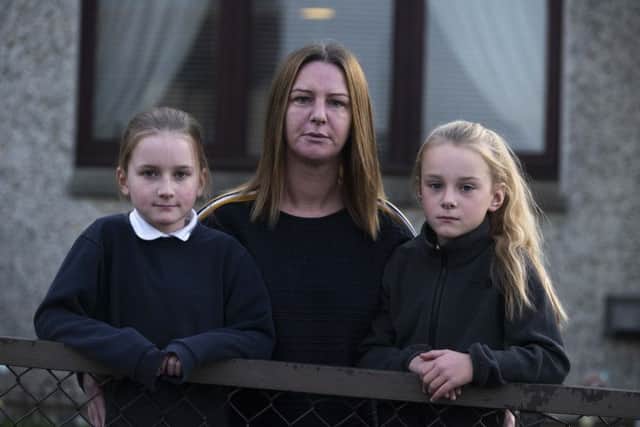 Daisy Showler (right), 9, is moving school after years of bullying at Stobhill Primary. Daisy is pictured with her mother Lynsey Showler and twin sister Millie.