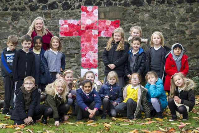 09/11/2018. St Ninian & Triduana church Restalrig: Local children in a creative euphoria have gone poppy mad. Children pose for a group picture in the church grounds.