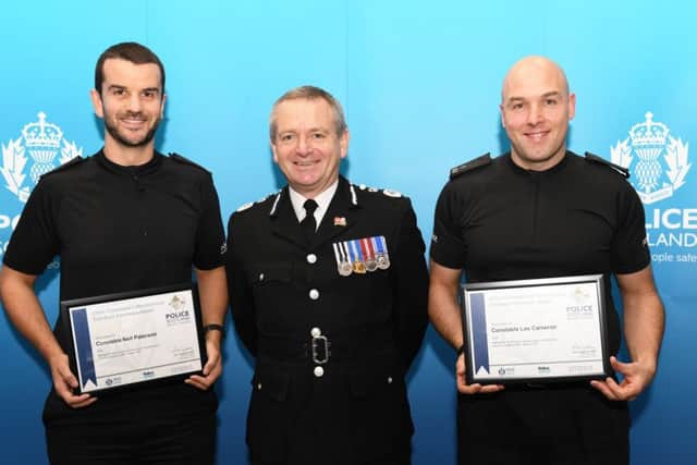 Constables Neil Paterson and Lee Cameron are handed their bravey awards
