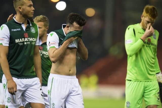Hibs players leave the field disappointed after falling to a 1-0 defeat at Aberdeen. Picture: SNS/Ross Parker