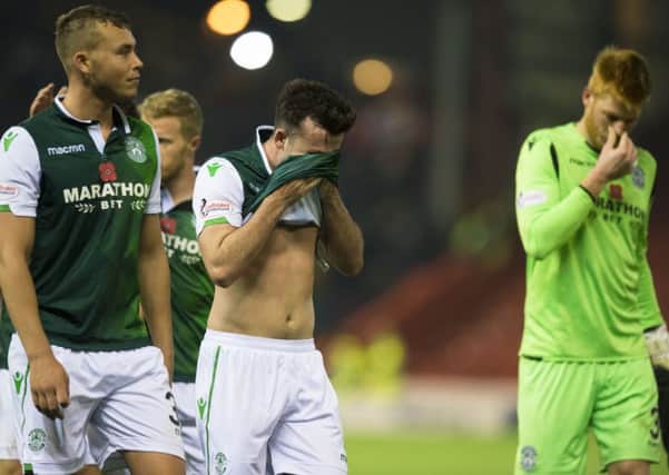 Hibs players leave the field disappointed after falling to a 1-0 defeat at Aberdeen. Picture: SNS/Ross Parker