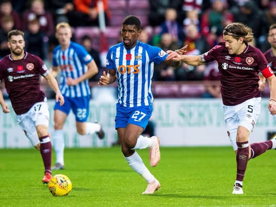 Aaron Tshibola of Kilmarnock is chased by Hearts captain Peter Haring.