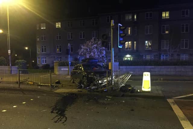 An estate car has crashed into a set of Traffic lights at a crossing on Queensferry Road. Pic: Johnston Press