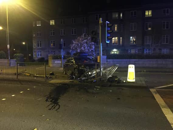 An estate car has crashed into a set of Traffic lights at a crossing on Queensferry Road. Pic: Johnston Press