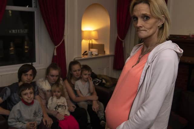 Pregnant Alana Burns with six of her children in the flat they are desperate to leave.