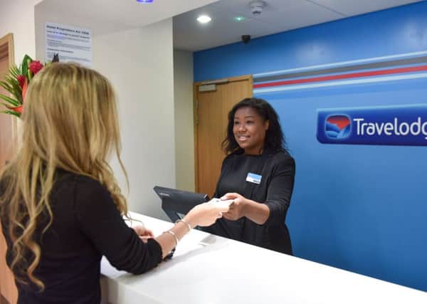 Pic by Michael Scott/Caters News - (PICTURED: Assistant Manager, Erica Mousah helps a customer at Travelodge in Dudley town centre.)