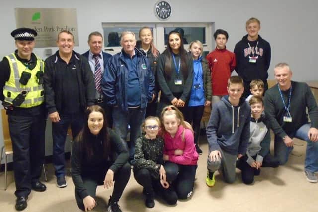 PC Robertson, Graham Hay and Keith Hay, of Dalkeith Miners Club, and Stephen Dixon, with young footballers.