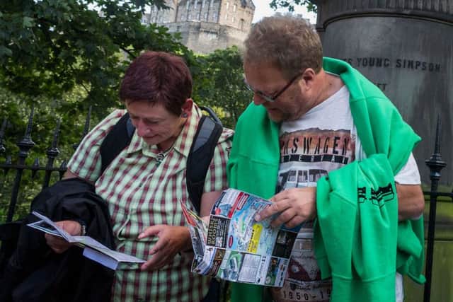 Tourists consult their own maps in Princes Street. Picture: Scott Taylor