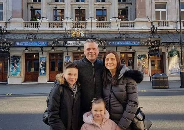 Luke Davidson
the family outside Her Majesty's Theatre in London where he performed last November.