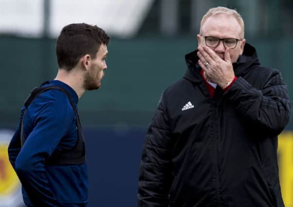 Alex McLeish consults with his captain Andy Robertson, left. McLeish has not had his troubles to seek this week