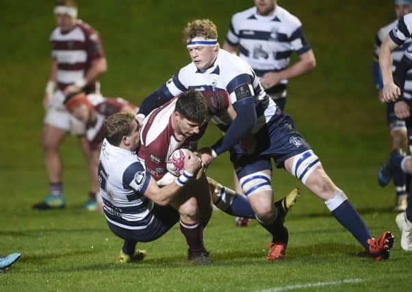Watsonians player Ross Graham is the meat in the sandwich as Iain Wilson and Adam Sinclair grab him.  Pic: Greg Macvean