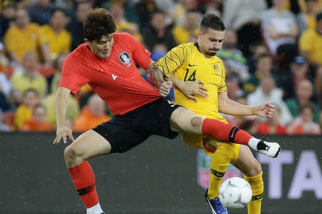 Jamie Maclaren battles for the ball with South Korea's Min-Jae Kim. Picture: Getty Images