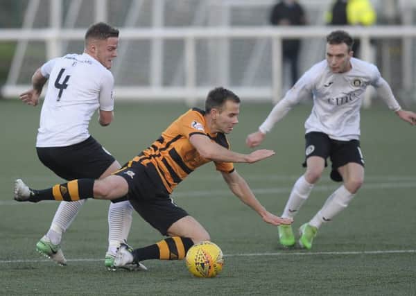 Alloa's Alan Trouten goes down under pressure from Andy Black and Graham Taylor. Picture: Neil Hanna