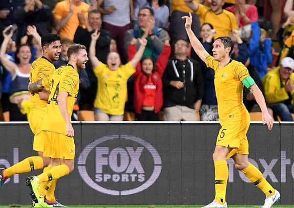 Massimo Luongo of Australia celebrates with team-mates Mark Milligan and Martin Boyle after scoring against South Korea. Picture: Bradley Kanaris/Getty Images
