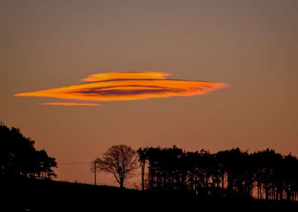 A cloud shaped like a flying saucer captured in the sky over some trees near Biggar, South Lanarkshire. Pic: Fiona Pagett.