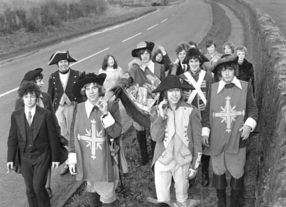 The Bay City Rollers walked from the GPO in Edinburgh to Nazareth House in Lasswade to deliver Christmas presents to the children's home in December 1967. Seen in picture, manager Tam Paton (left, with moustache) Alan Longmuir and Derek Longmuir (at front).
