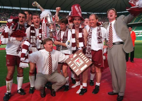Jim Jefferies, front, celebrates Hearts' cup win with his players