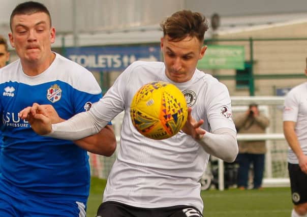 Defender Liam Henderson is happy to keep out the goals as Blair Henderson scores at the other end