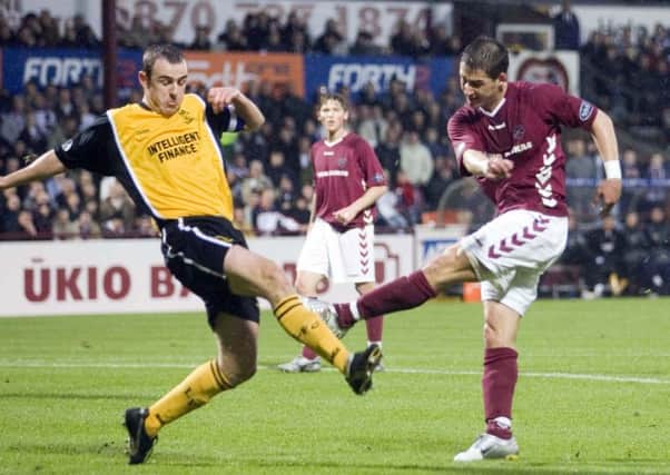 Rudi Skacel fires home Hearts' second goal under a challenge from Dave Mackay