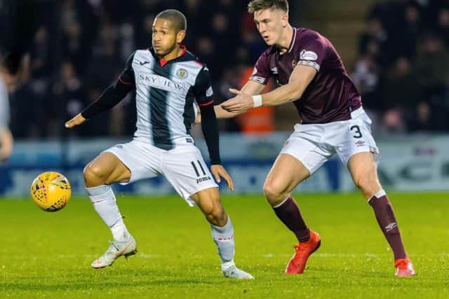 Jimmy Dunne puts pressure on St Mirren striker Simeon Jackson.