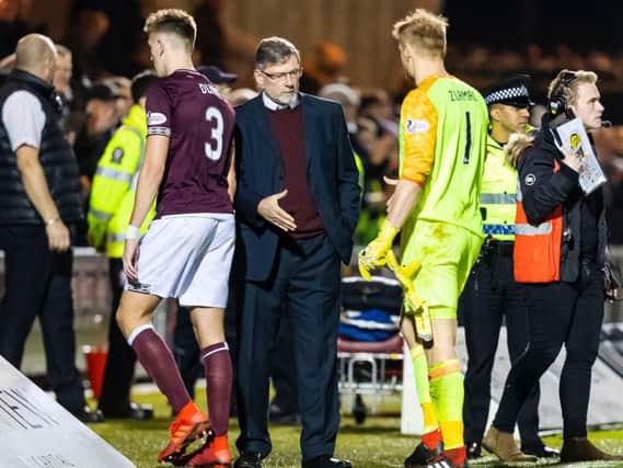 Craig Levein shakes hands with his players as they make their way off the park following the defeat to St Mirren.
