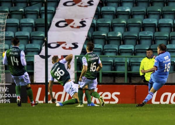 Paul McGowan, far right, curls the ball beyond Hibs goalkeeper Adam Bogdan (not pictured) to earn Dundee a point at Easter Road. Pic: SNS