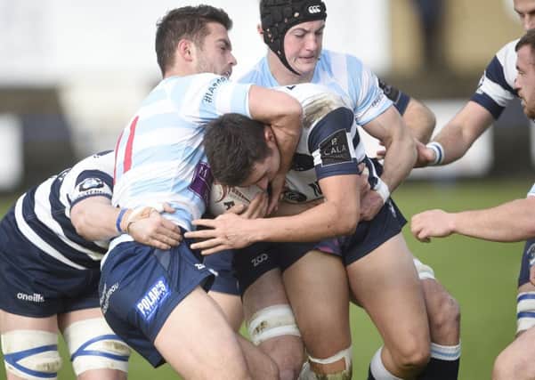 Cameron Lineen of Heriot's grapples with Robbie Kent