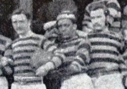 James Robertson stands alongside two Scottish internationals.