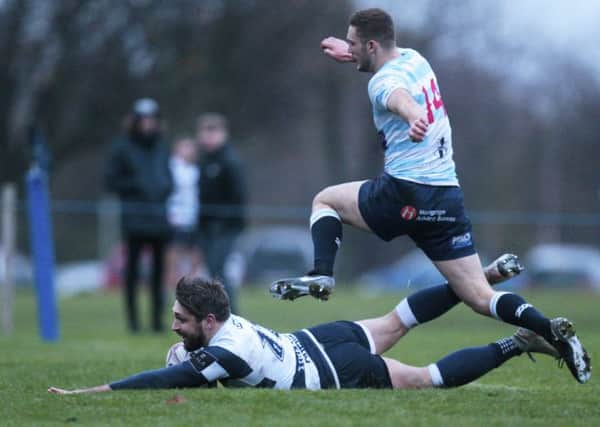 Craig Robertson of Heriot's goes over for the final try