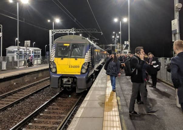 Passengers at Uphall after the three carriages were left behind by the train.