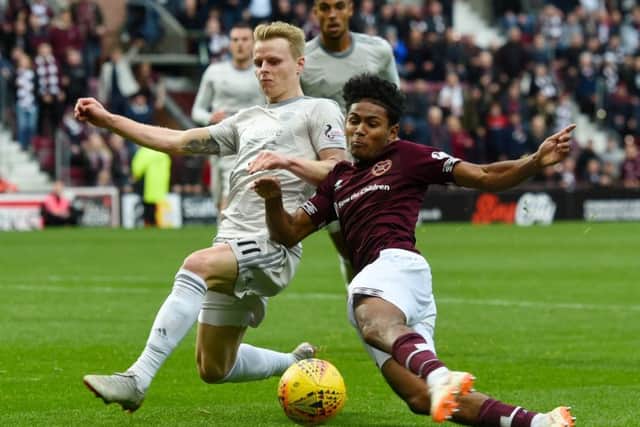 Demetri Mitchell slides in against Aberdeen's Gary Mackay-Steven in one of his strongest displays for Hearts