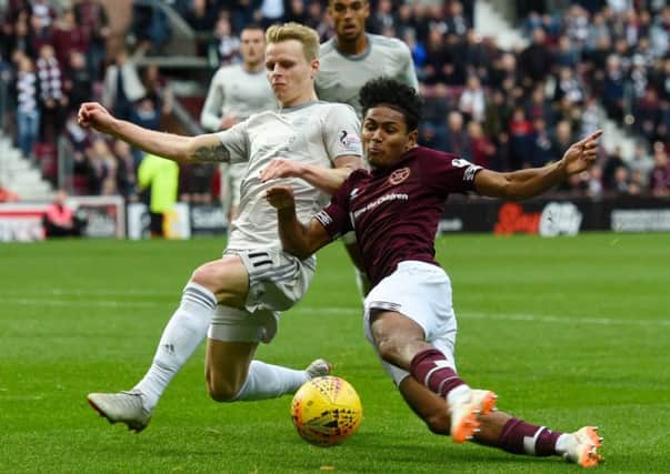Demetri Mitchell slides in against Aberdeen's Gary Mackay-Steven in one of his strongest displays for Hearts
