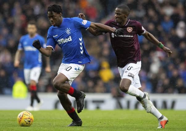 Arnaud Djoum, right, chases after Ovie Ejaria during Hearts' 3-1 defeat at Ibrox. Picture: SNS