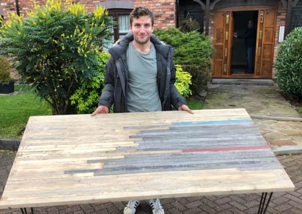 Callum Skinner with the table made from the old velodrome. Picture: Twitter