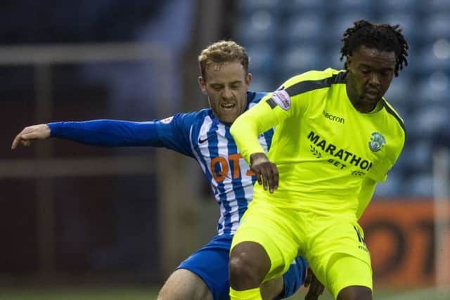 Hibs' Miquel Nelom challenges Rory McKenzie during the 3-0 defeat by Kilmarnock. Pic: SNS