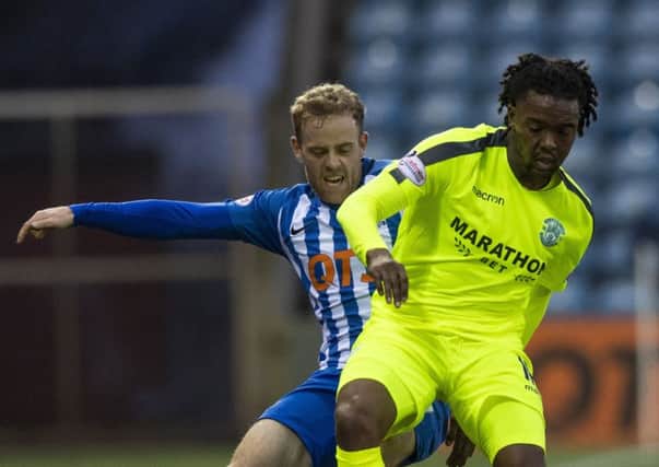 Hibs' Miquel Nelom challenges Rory McKenzie during the 3-0 defeat by Kilmarnock. Pic: SNS