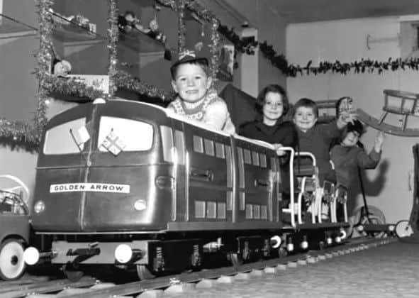 Children play on the model of the Golden Arrow engine in Jenners, Edinburgh, November 1965.