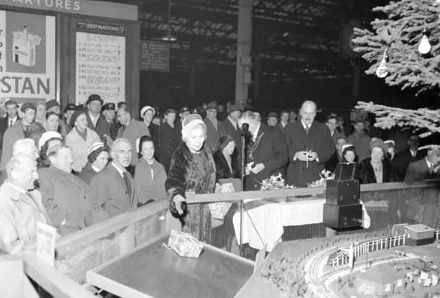 Dozens of locals gather at Waverley Station to catch a glimpse of the Christmas tree.