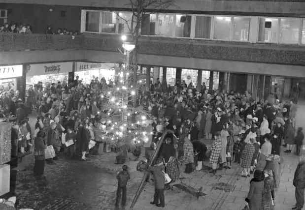 Christmas tree and carol singers at the Kirkgate shopping centre in Leith.