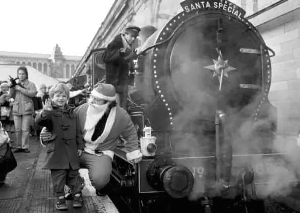 Michael Fielden, 4, and Father Christmas beside the Scottish Railway Preservation Society's steam locomotive Maude at Waverley station, running the Santa Special.