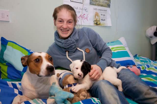 Natasha Robins with her dog Harper and its newborn puppies at Dunedin Harbour. Picture: Gary Baker/PA Wire