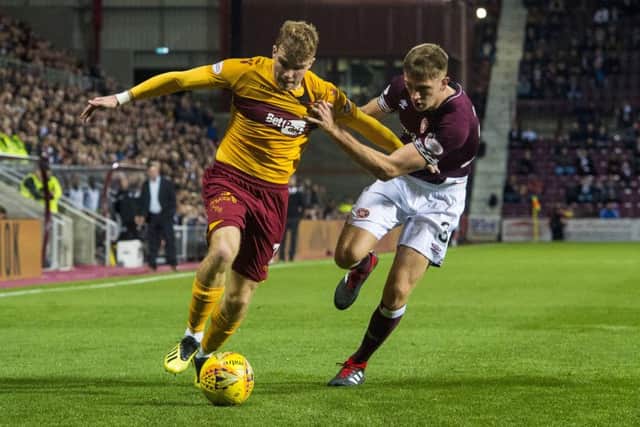 Chris Cadden and Hearts' Jimmy Dunne battle for possession during the Betfred Cup quarter-final in September. Picture: SNS