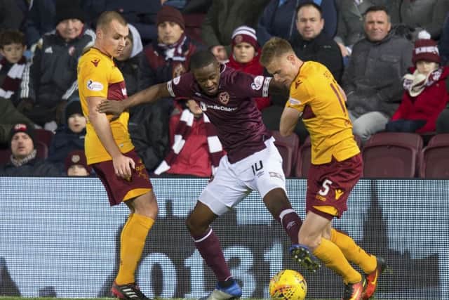 Arnaud Djoum takes on two Motherwell players. Picture: SNS Group